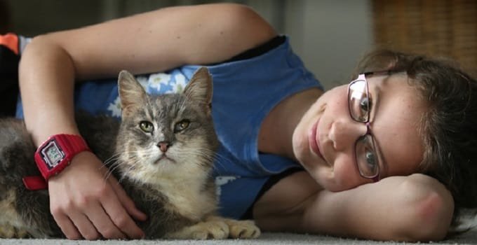 Danika Fisher, 10, with cat K Bear after it went missing for four years. Photo/John Borren