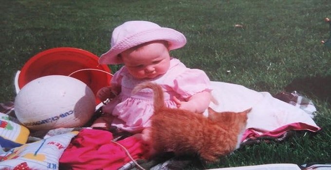 Caitlin McClelland as a child with her cats