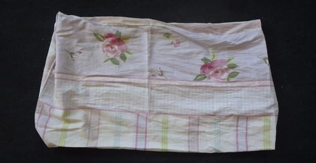 A pillow case with a floral design was used to tie up by the kitten. Credit: RSPCA
