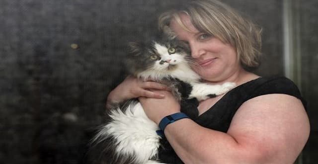 Marnie Singer poses with her cat, Freddie. Singer runs the Winnipeg Missing and Found Cat Watch Facebook page and has helped reunite "hundreds" of lost cats with their owners.
